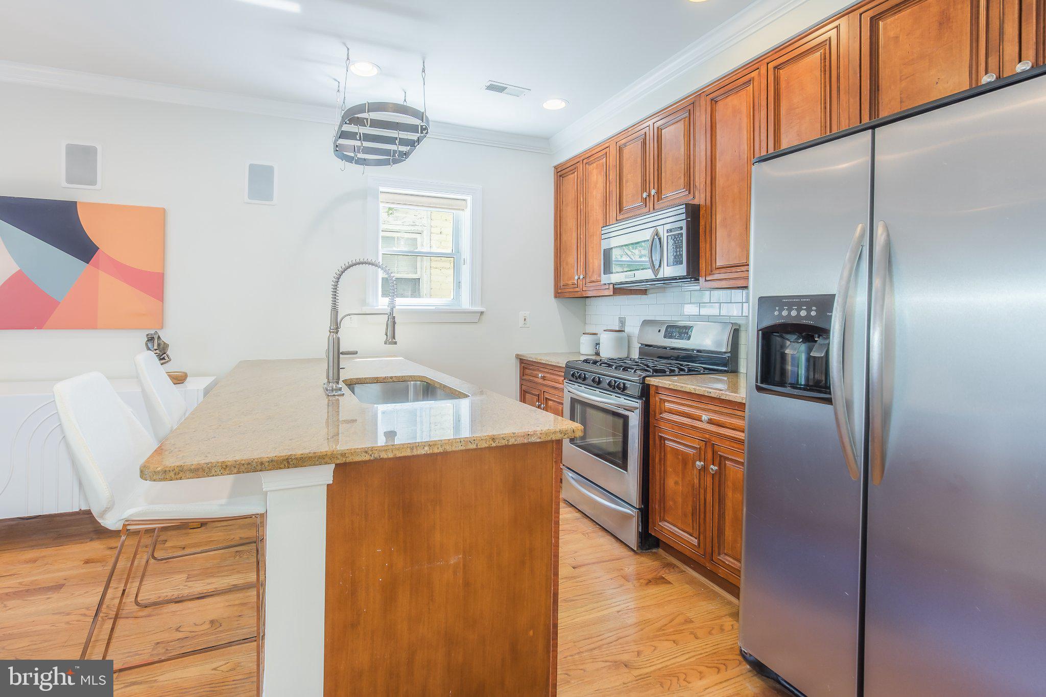 1116 C Street Northeast, Unit 202 Washington, DC 20002 - Photo 13 of 30 Modern kitchen with warm wood accents.