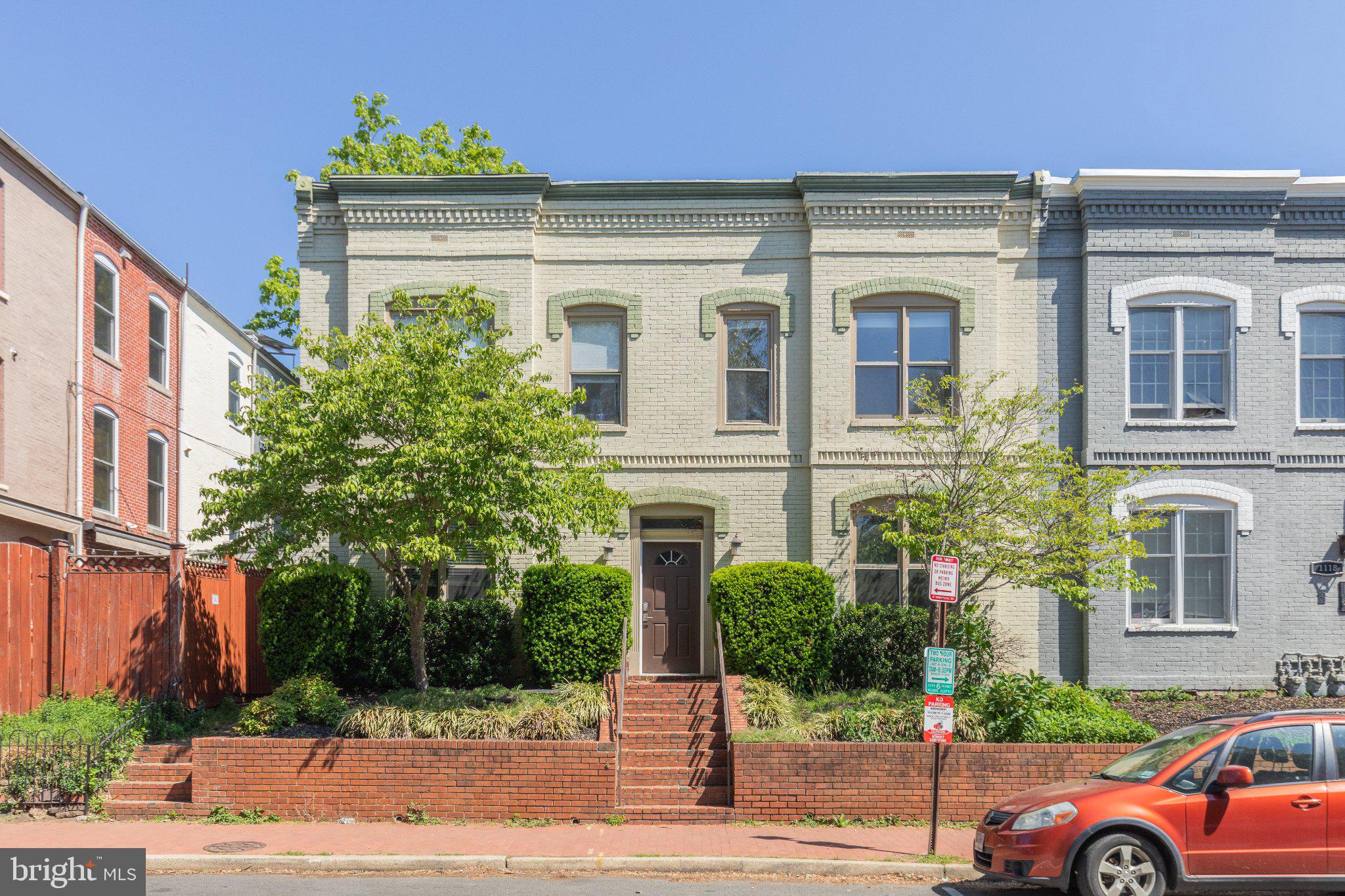 1116 C Street Northeast, Unit 202 Washington, DC 20002 - Photo 2 of 30 Charming brick facade with lush greenery.
