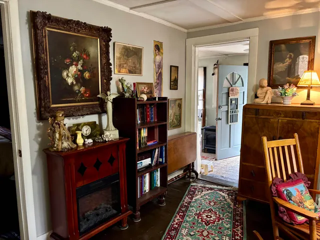 a living room with furniture a rug and a fireplace