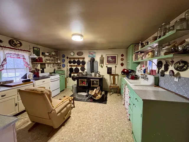 a living room with lots of furniture and clutter