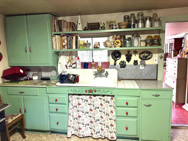 a kitchen with a cabinets and a wooden floor