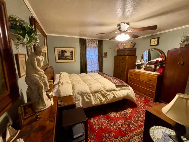 a bedroom with bed and a chandelier