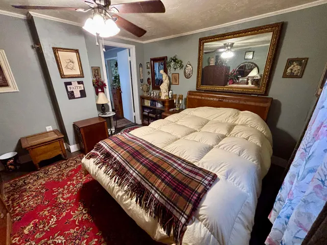 a bedroom with a bed and a chandelier