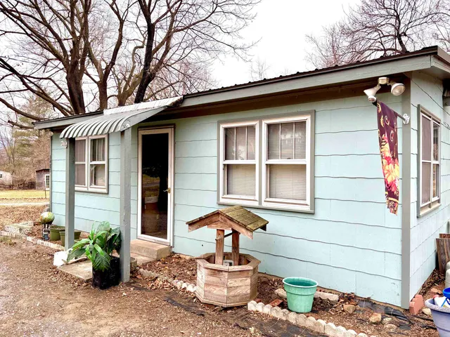 a front view of a house with sitting area
