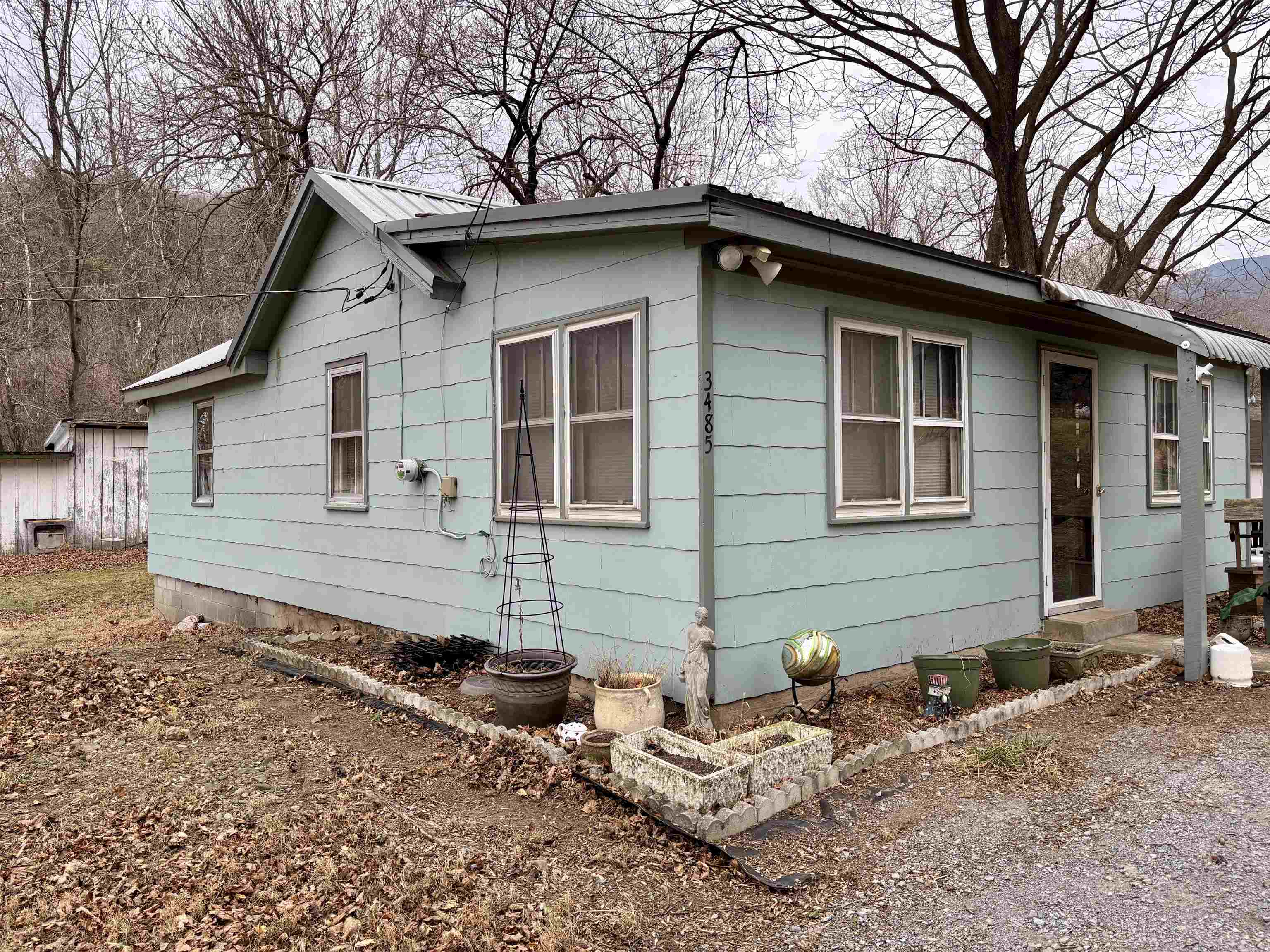 3485-3465 Pine Grove Road Stanley, VA 22851 - Photo 34 of 47 a backyard of a house with wooden fence and large trees