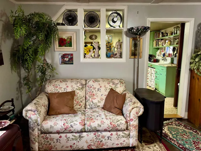 a living room with furniture and painting on the wall