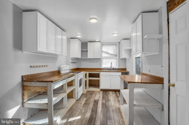 a kitchen with a stove a sink and a refrigerator