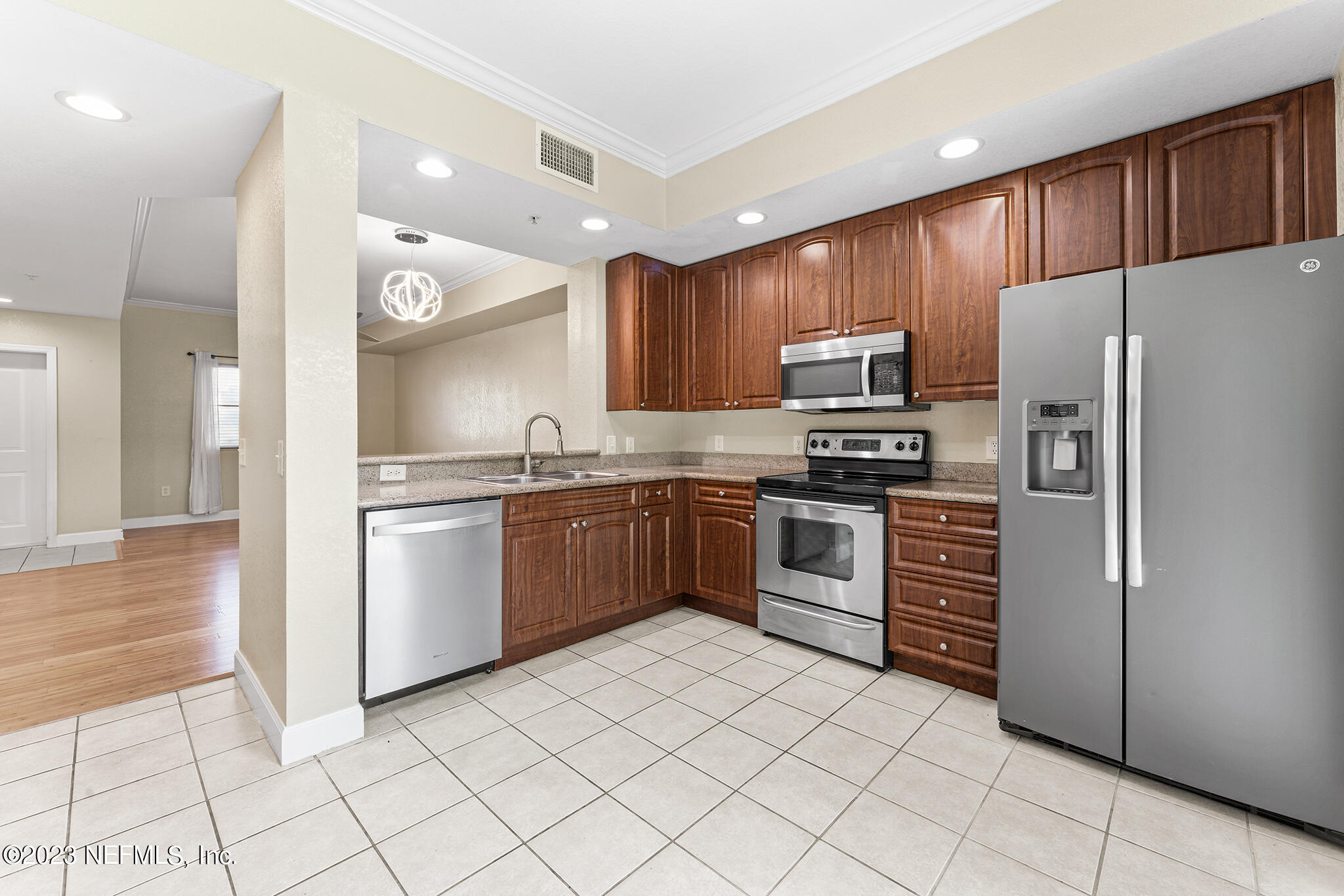 9745 Touchton Road, Unit 2003 Jacksonville, FL 32246 - Photo 11 of 34 a kitchen with granite countertop a refrigerator and a sink
