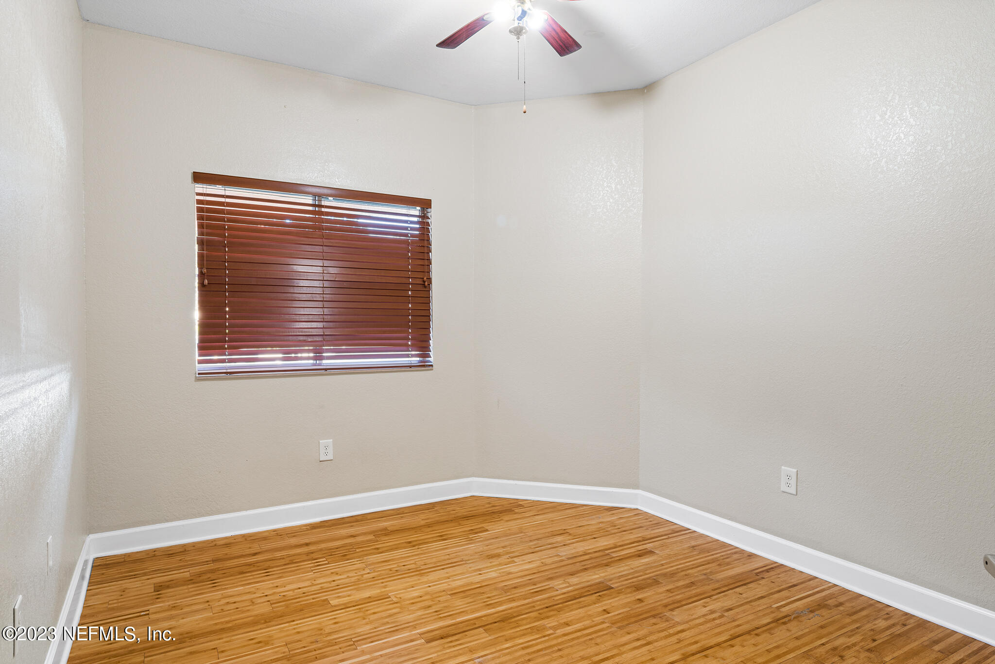 9745 Touchton Road, Unit 2003 Jacksonville, FL 32246 - Photo 18 of 34 a view of an empty room with wooden floor and a window
