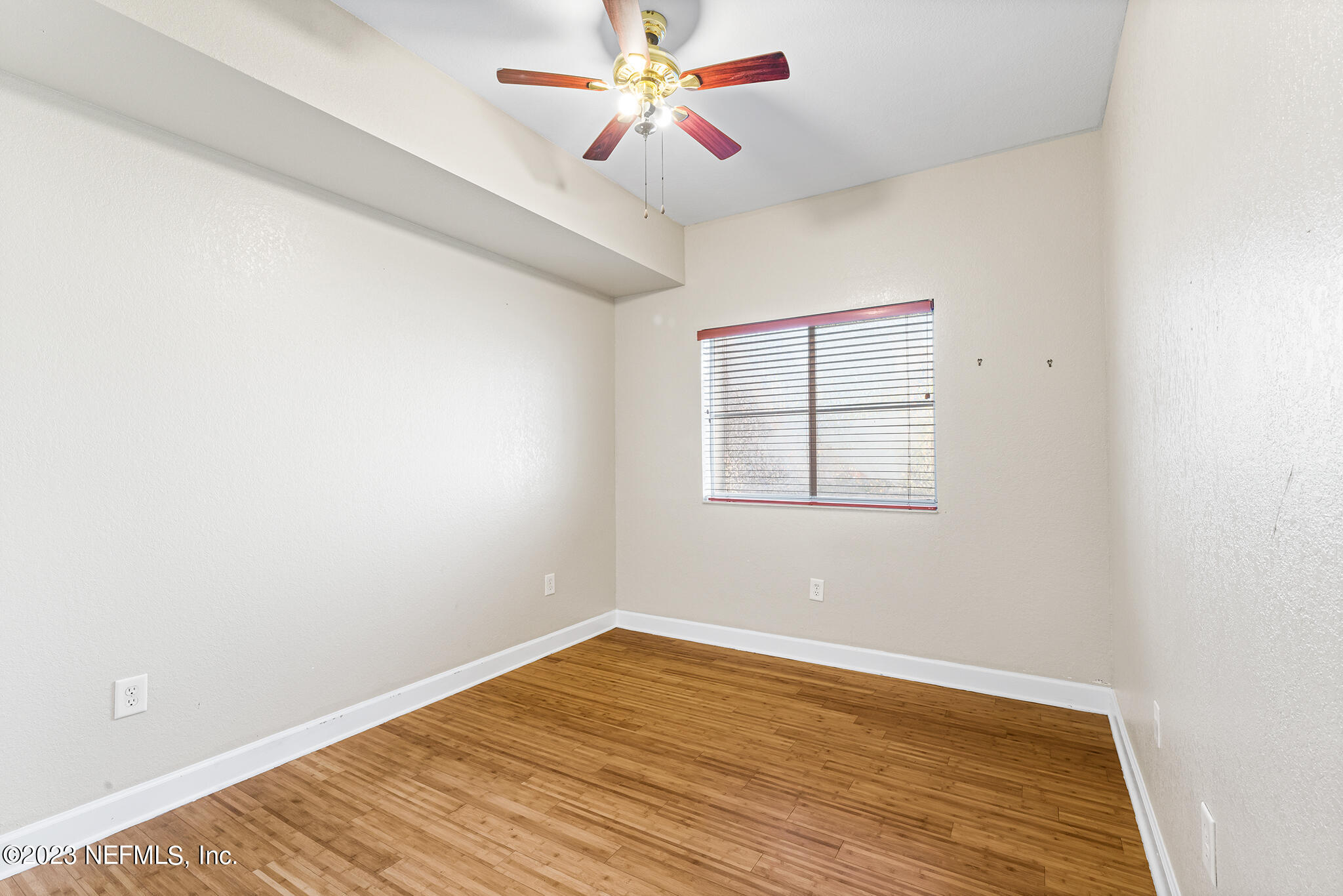9745 Touchton Road, Unit 2003 Jacksonville, FL 32246 - Photo 21 of 34 an empty room with wooden floor ceiling fan and windows