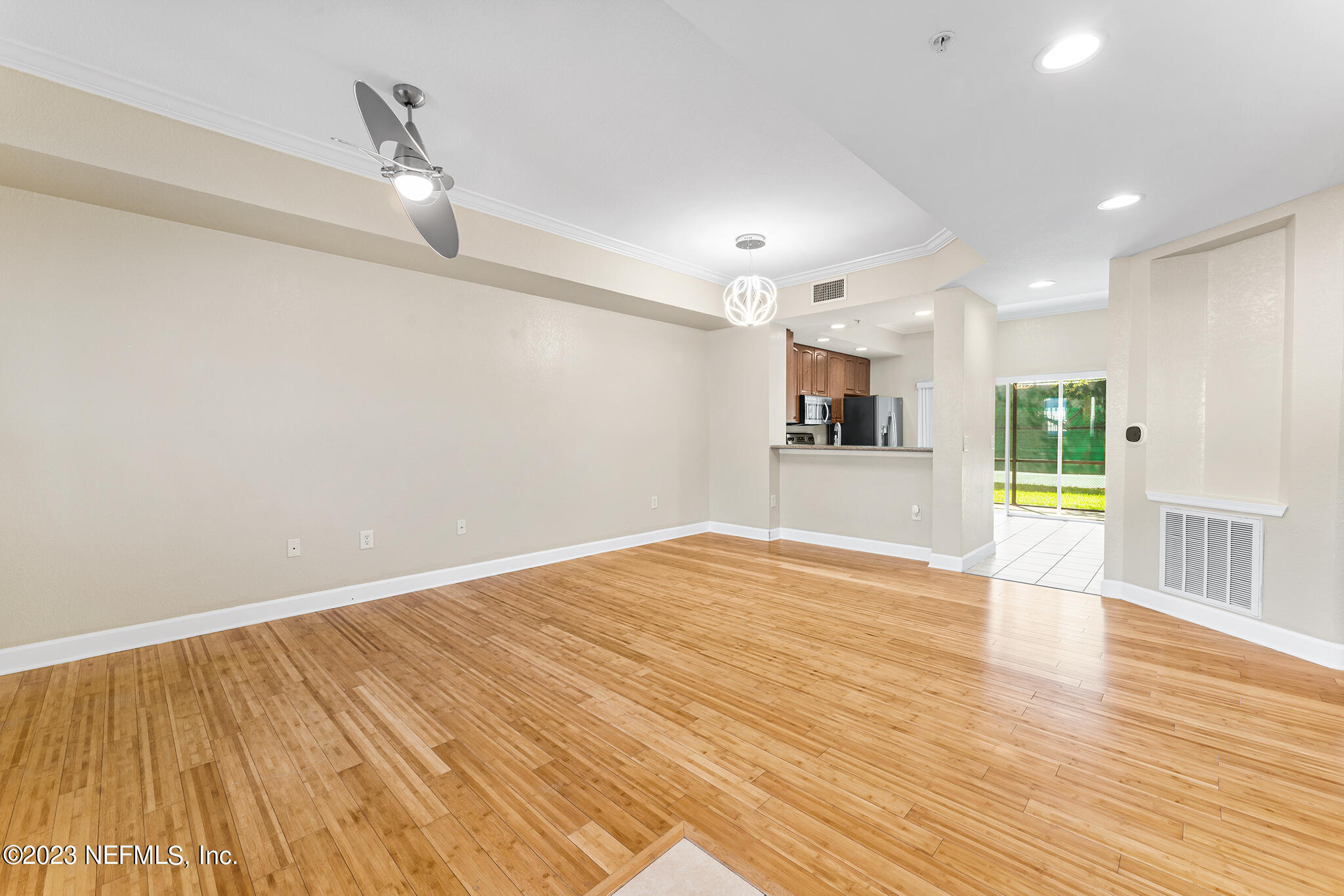 9745 Touchton Road, Unit 2003 Jacksonville, FL 32246 - Photo 4 of 34 a view of an empty room with wooden floor and a window