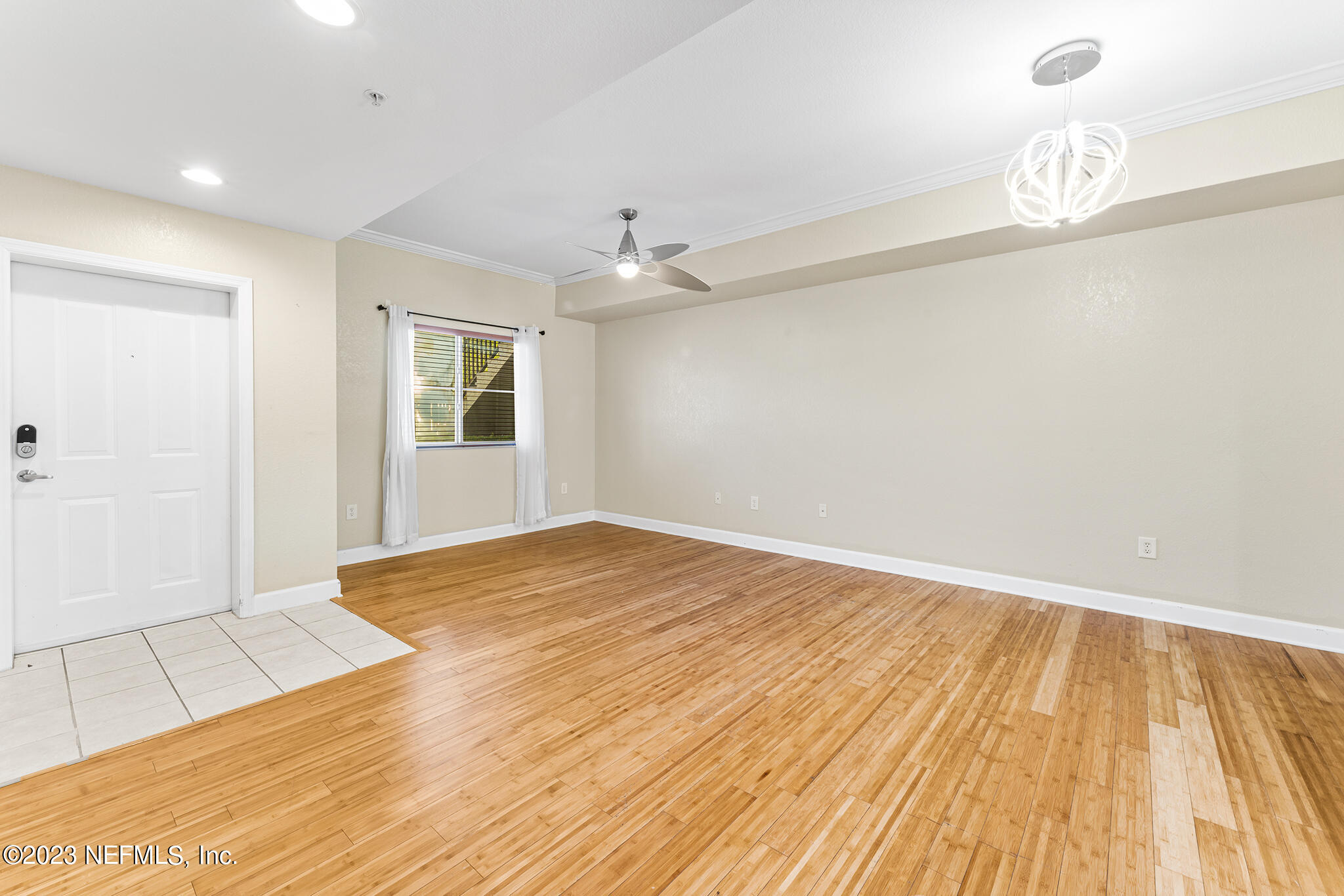 9745 Touchton Road, Unit 2003 Jacksonville, FL 32246 - Photo 5 of 34 wooden floor in an empty room with a window