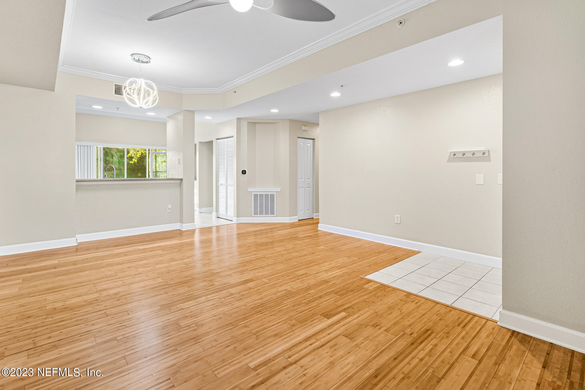 9745 Touchton Road, Unit 2003 Jacksonville, FL 32246 - Photo 7 of 34 an empty room with wooden floor and windows