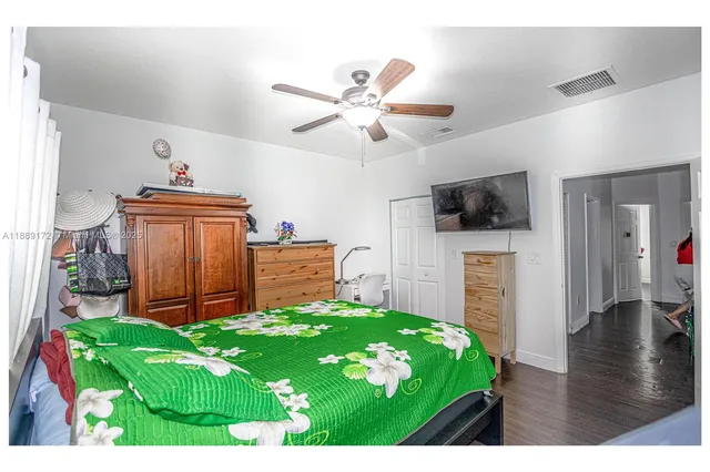 a living room with kitchen view and flat screen tv