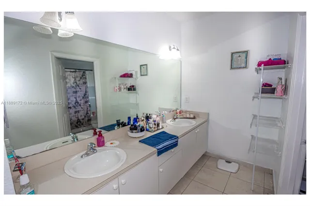 a bathroom with a sink mirror and vanity