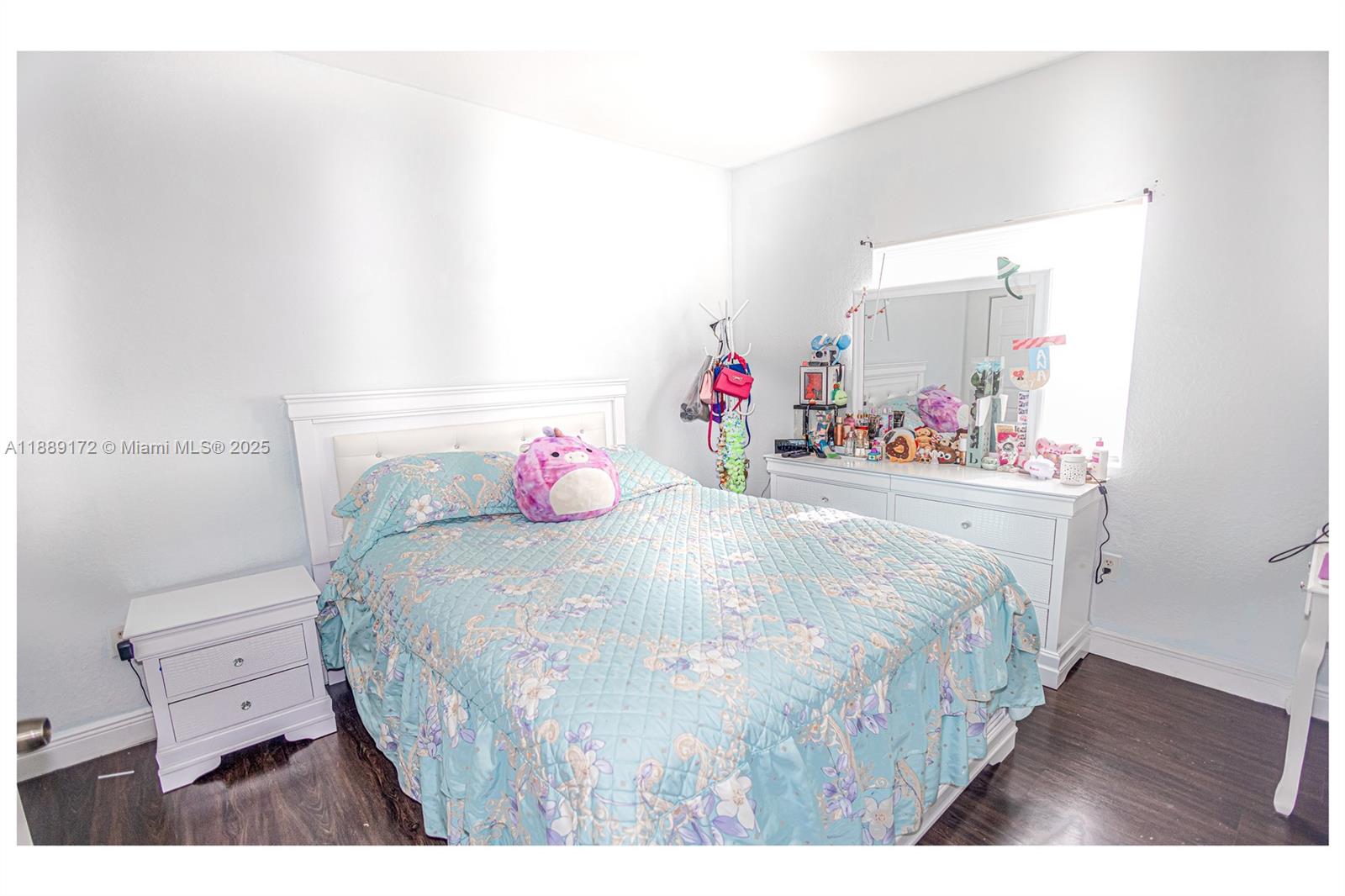 18272 Southwest 108th Path Miami, FL 33157 - Photo 13 of 27 a bedroom with a bed a dresser and wooden floor