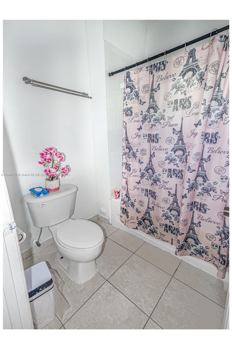 18272 Southwest 108th Path Miami, FL 33157 - Photo 14 of 27 a bathroom with a toilet sink and shower curtain