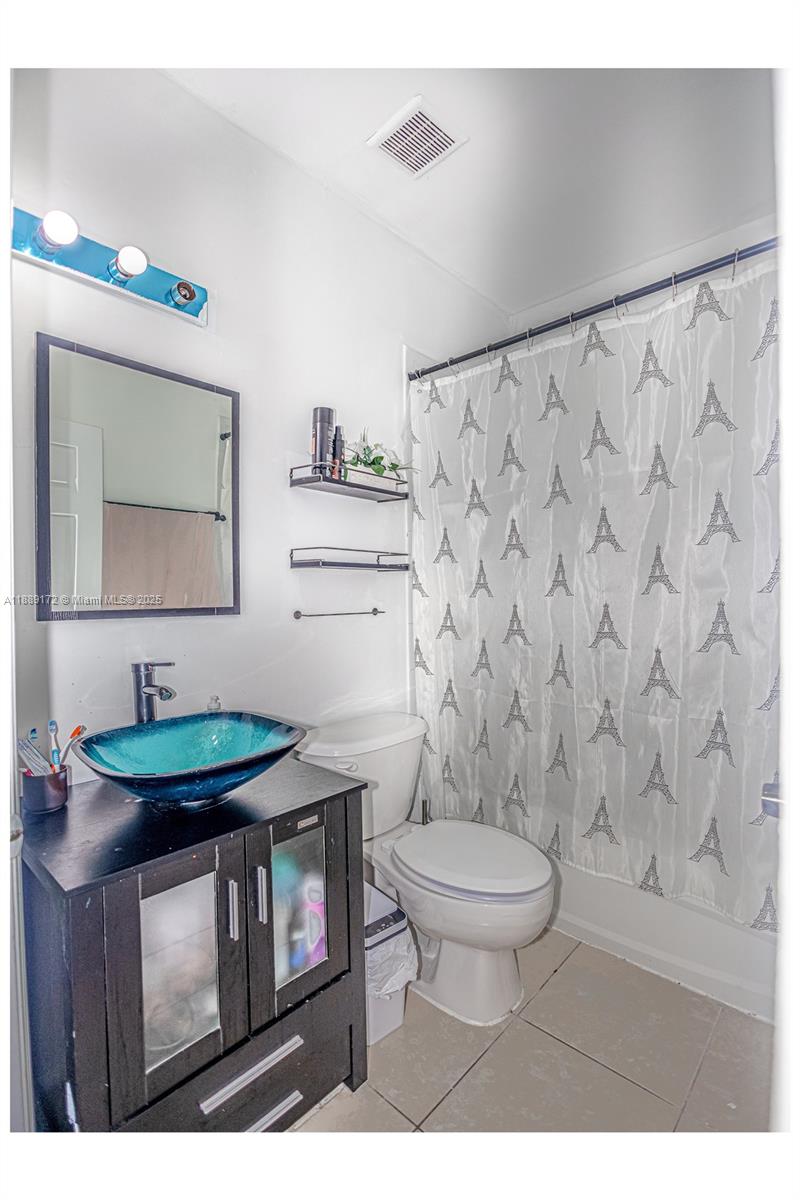 18272 Southwest 108th Path Miami, FL 33157 - Photo 16 of 27 a bathroom with a sink toilet and mirror