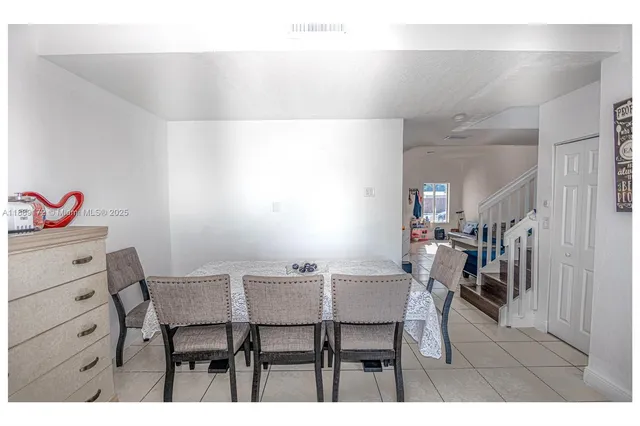 a view of a dining room with furniture and a chandelier