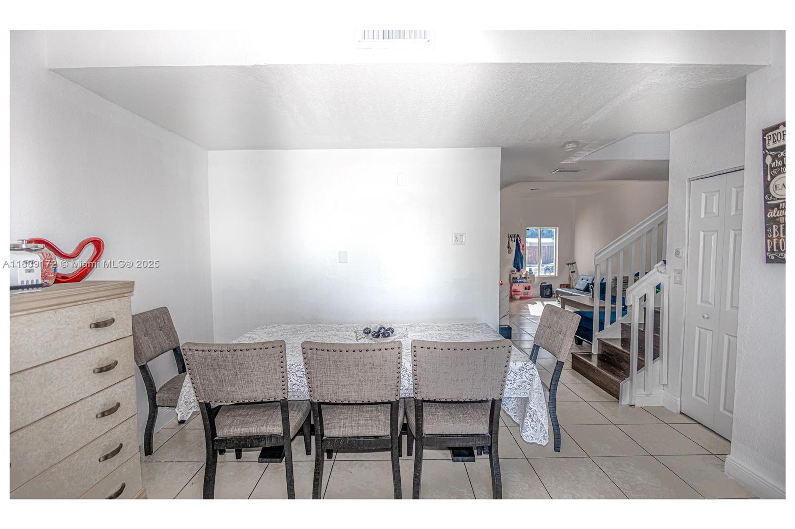 18272 Southwest 108th Path Miami, FL 33157 - Photo 22 of 27 a view of a dining room with furniture and a chandelier