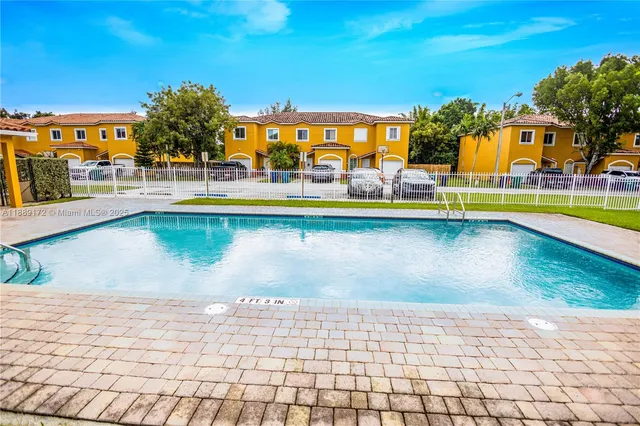 a view of swimming pool with outdoor seating and city view