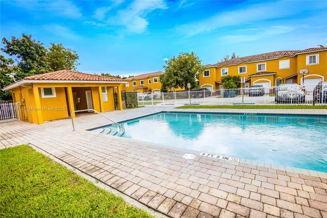 a house with swimming pool in front of it
