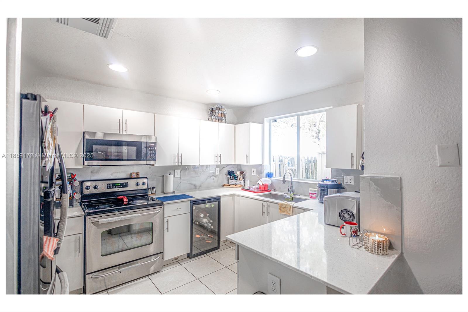 18272 Southwest 108th Path Miami, FL 33157 - Photo 6 of 27 a kitchen with a stove a sink and a microwave