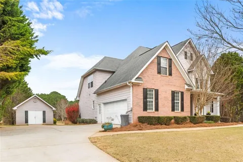 a bathroom with a granite countertop sink a large mirror and a shower