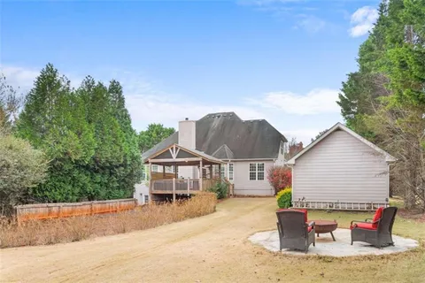 a living room with furniture kitchen view and a chandelier