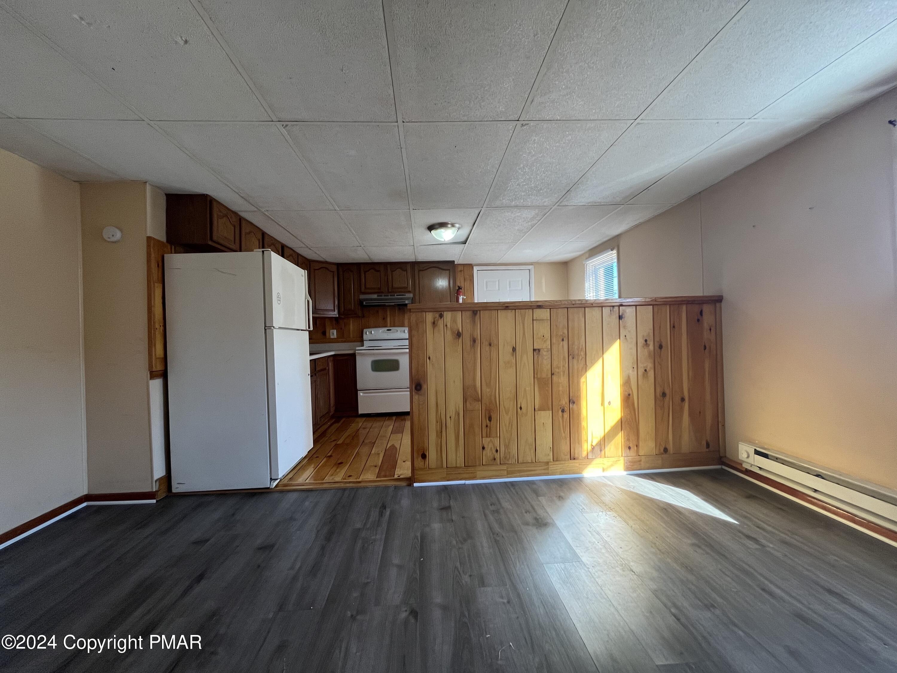 501 North Railroad Street Tamaqua, PA 18252 - Photo 4 of 7 a view of a kitchen with wooden floor and a refrigerator