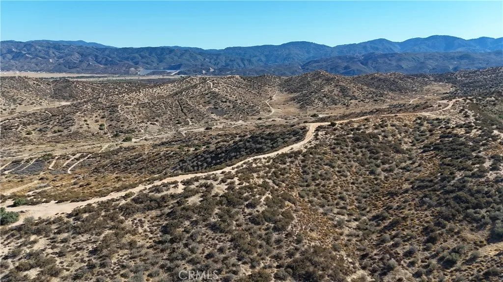 a view of a field with mountains in the background