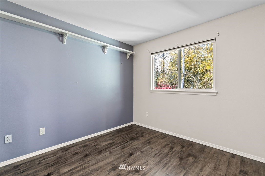 459 Field Place Northeast Renton, WA 98059 - Photo 22 of 40 a view of an empty room with wooden floor and a window