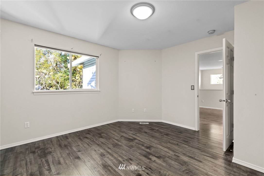 459 Field Place Northeast Renton, WA 98059 - Photo 23 of 40 an empty room with wooden floor and windows