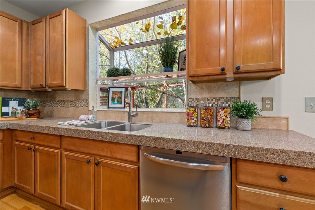 459 Field Place Northeast Renton, WA 98059 - Photo 8 of 40 a kitchen with stainless steel appliances granite countertop white cabinets and a window