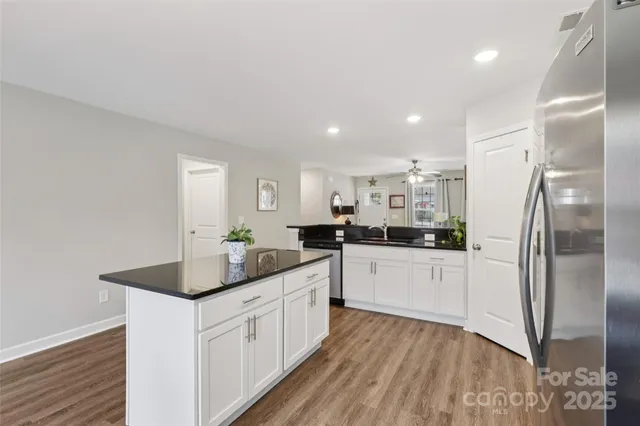 a kitchen with white cabinets and stainless steel appliances