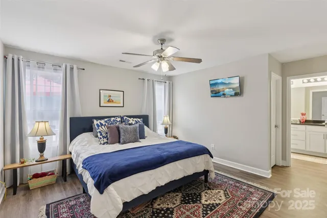 a bedroom with a large bed and a chandelier