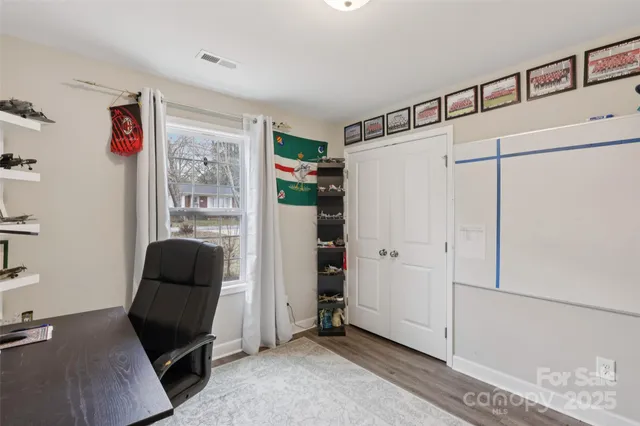 a bedroom with a bed and a chair