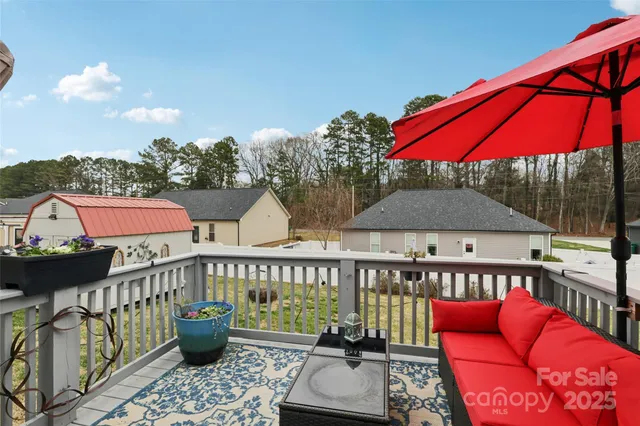 an outdoor sitting area with furniture and umbrella