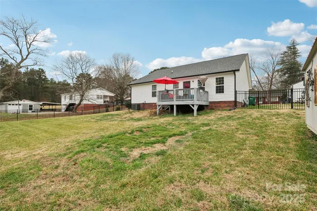 a backyard of a house with table and chairs