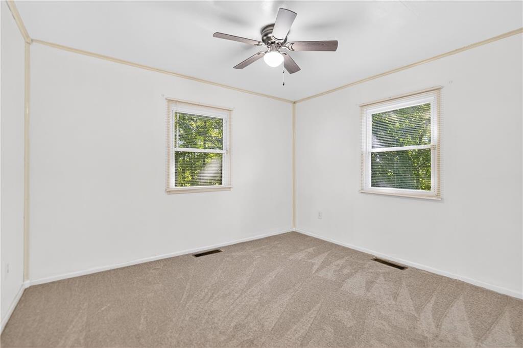 1660 The Circle Washington, PA 15301 - Photo 23 of 50 an empty room with a window and a ceiling fan