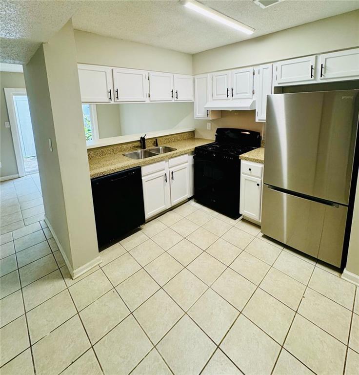 2074 Oak Park Lane Decatur, GA 30032 - Photo 5 of 17 a kitchen with a sink a refrigerator and a stove top oven