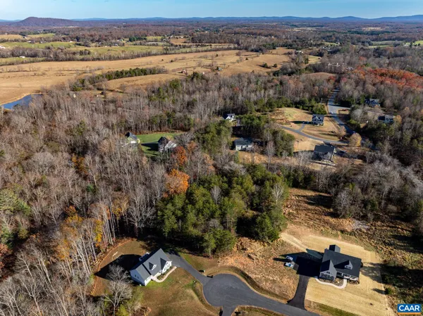 an aerial view of a houses with a lake view
