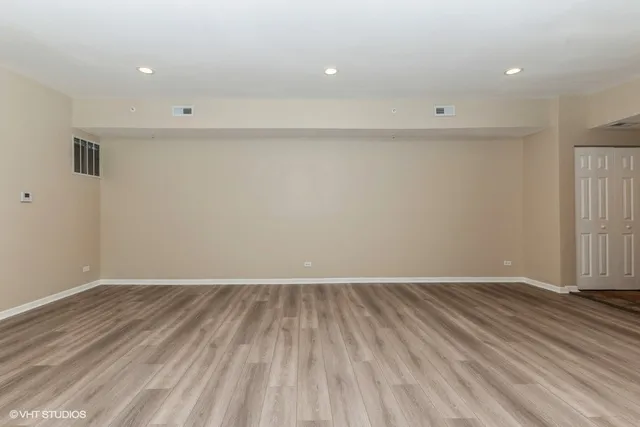 a view of room with wooden floor