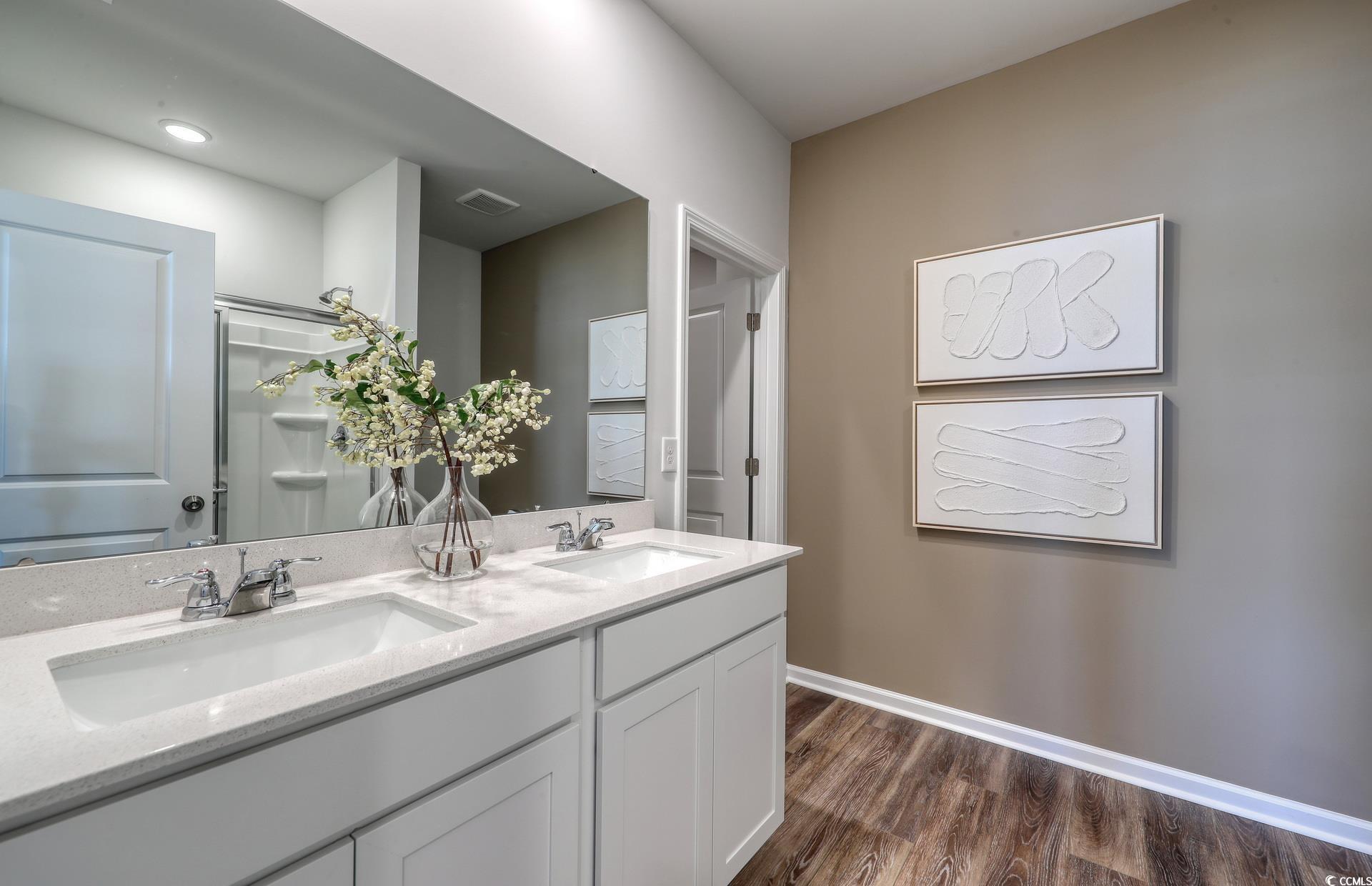 3081 Visionary Drive Myrtle Beach, SC 29588 - Photo 14 of 19 Bathroom featuring a shower stall, double vanity, and dark wood finished floors
