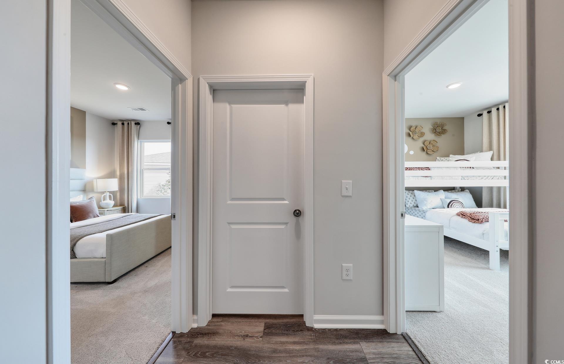 3081 Visionary Drive Myrtle Beach, SC 29588 - Photo 4 of 19 Hallway featuring dark carpet, dark wood-type flooring, and recessed lighting