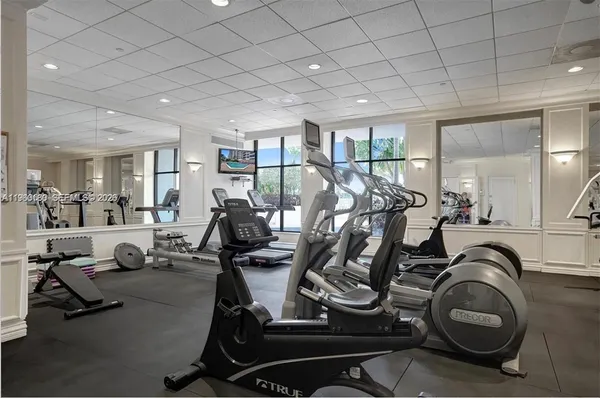 a room with gym equipment and windows