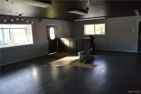 a living room with hard wood floors and a window