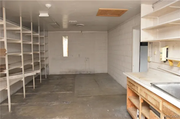a view of a kitchen with a sink and cabinets