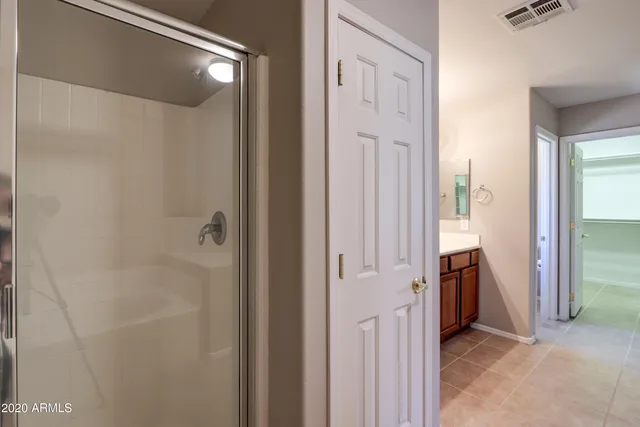 a bathroom with a granite countertop toilet a sink and shower