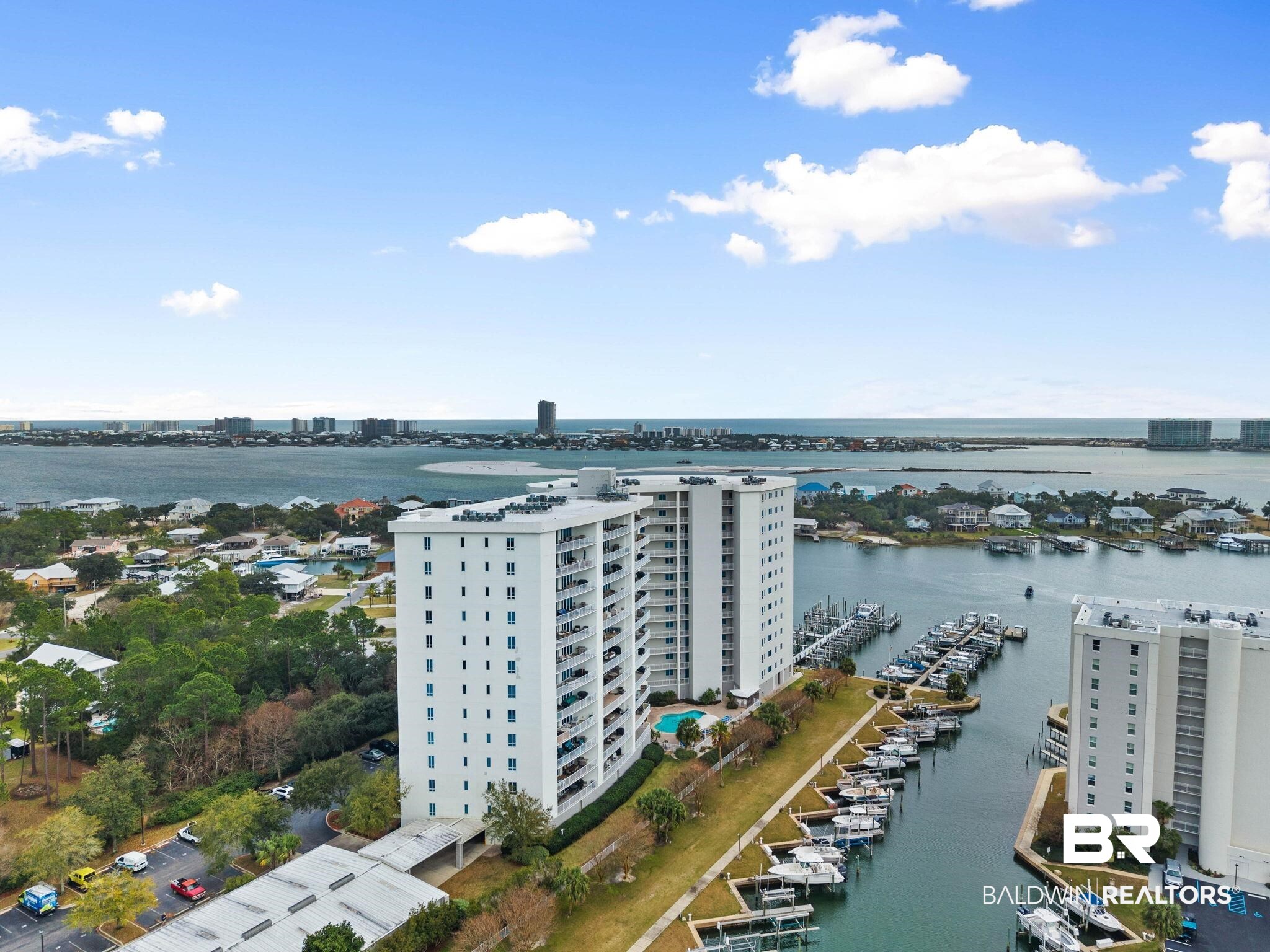 28250 Canal Road, Unit 208 Orange Beach, AL 36561 - Photo 45 of 53 Drone / aerial view of a nearby body of water and a marina